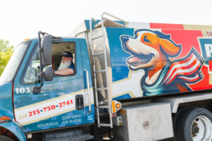 Driver in the cab of the Same Day Oil Delivery heating oil tanker