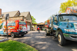 Patriot van and heating oil tanker in a customer driveway