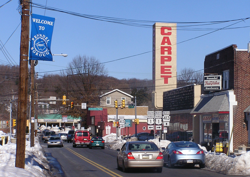 Penndel Pennsylvania Carpet sign and borough banner along Lincoln Highway showing local heating oil delivery area