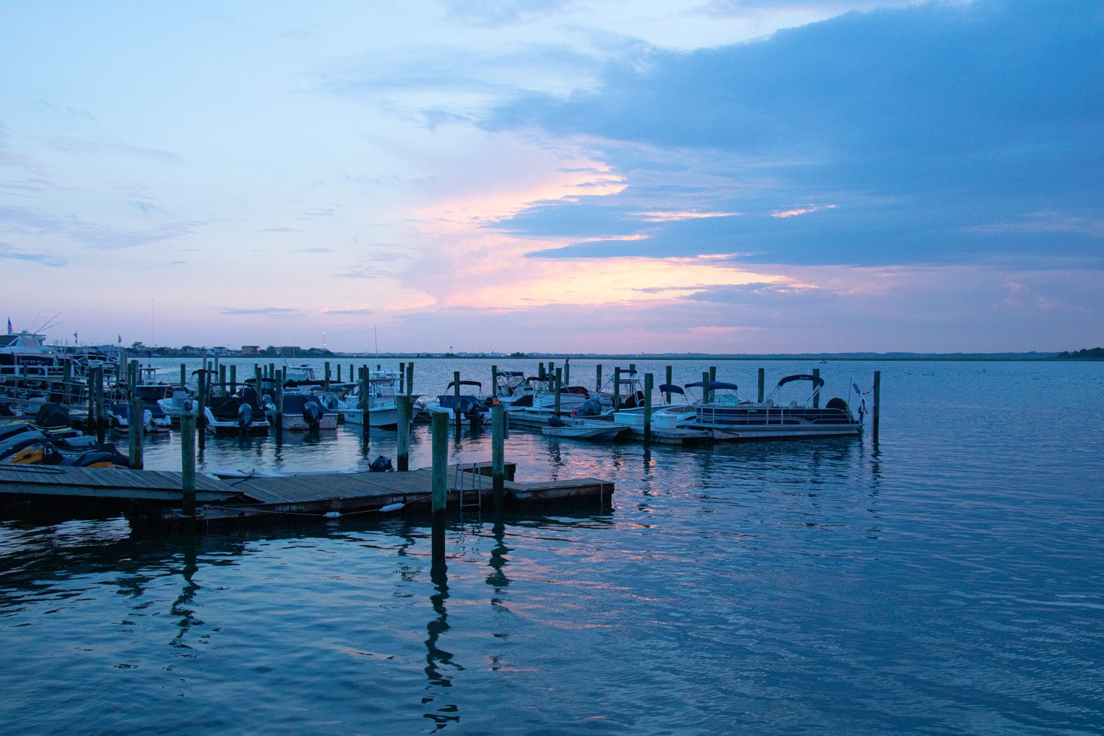 Boats at a back-bay marina at dusk, where marine diesel is delivered in Absecon, NJ
