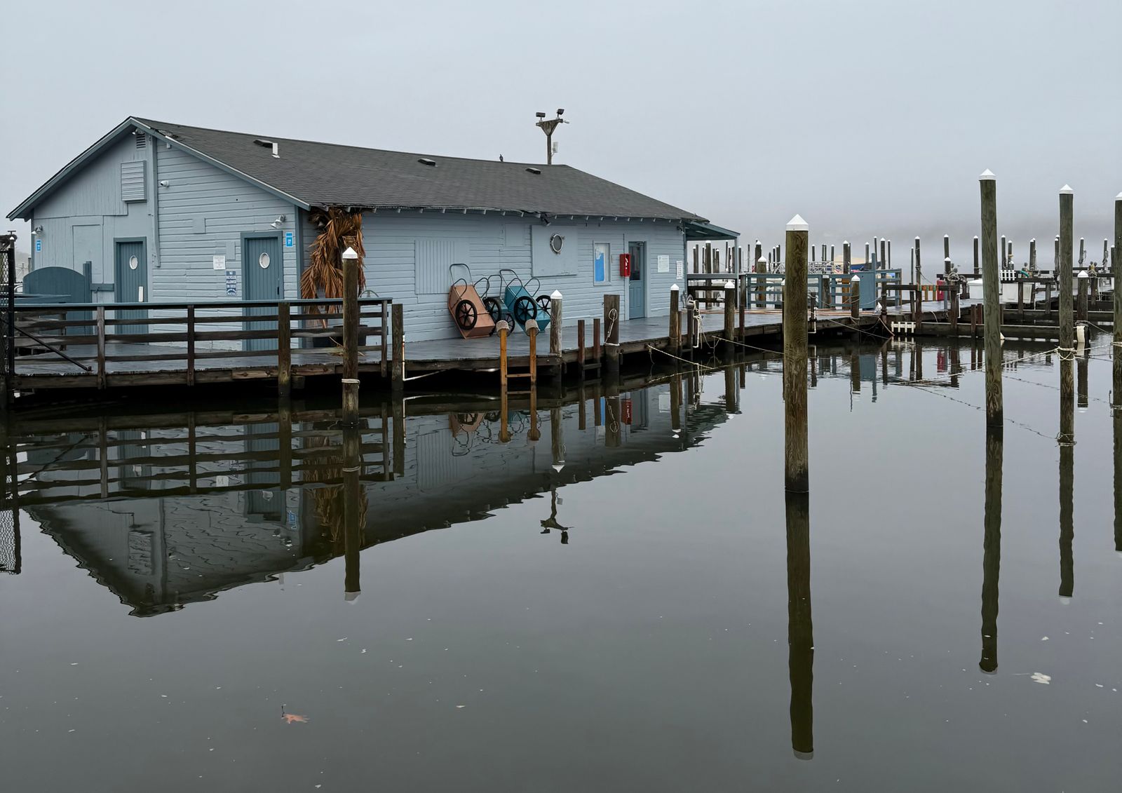 A marina dock house and floating docks on a foggy morning, where marine diesel is delivered in Smithville, NJ