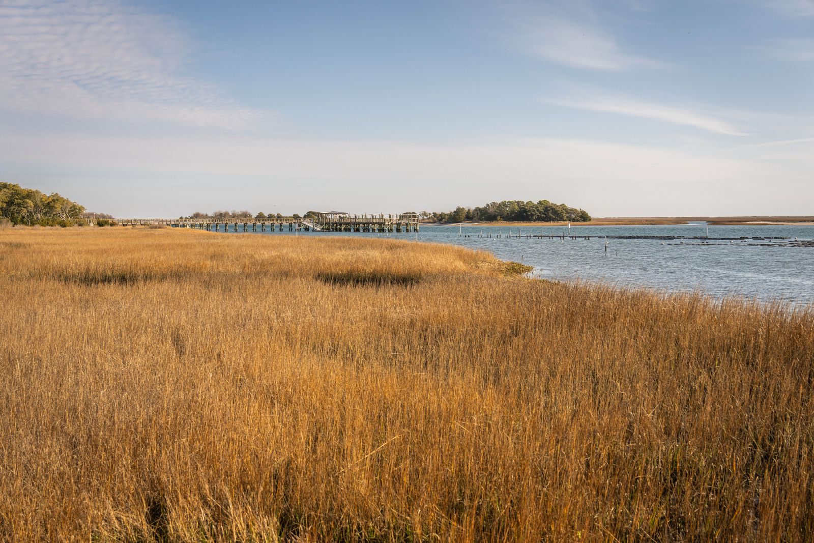 Salt marsh and a long pier reaching into a coastal bay, where marine diesel is delivered in Oceanville, NJ